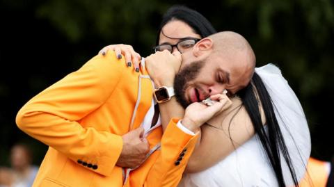 Otis Pena, friend of the former "Philadanco!" dancer O'Shae Sibley, who was stabbed to death in Brooklyn, reacts during his burial ceremony at Fernwood Cemetery in Lansdowne, Pennsylvania