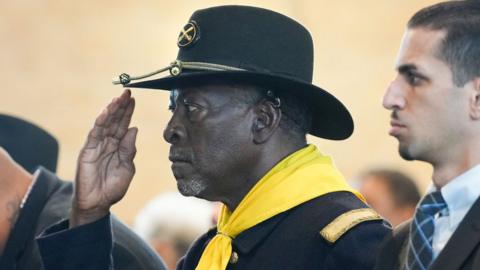 A Buffalo Solider salutes during the singing of the National Anthem before an event recognizing the legacy of the soldiers from the 3rd Battalion, 24th Infantry Regiment, at Buffalo Soldiers Museum on Monday, Nov. 13, 2023 in Houston.