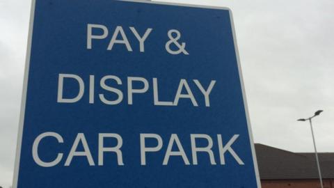Blue sign for pay and display car park