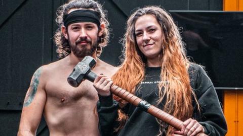 Taylor and Katie posing with a sledgehammer