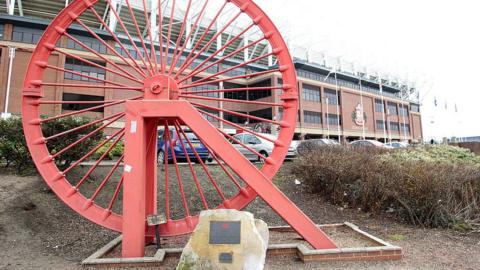 A pit wheel in front of the Stadium of Light, which now stands on the site of the what was Wearmouth Colliery
