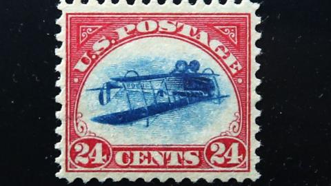 A rare stamp known as an "Inverted Jenny" is displayed at the World Stamp Show in Manhattan on June 2, 2016 in New York City. The stamp, one of the most famous stamps in American history, was stolen from a display case at a convention in 1955 and only located last March. The stamp, which features an airplane printed upside-down, only surfaced at a New York auction house in April when an Irish man who had inherited it brought it in. (