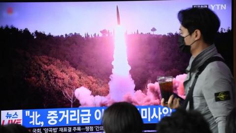 Commuters at a Seoul railway station watching a news report on North Korea firing another missile