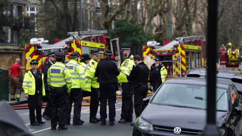 Met Police officers and firefighters at the scene