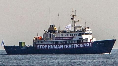 A banner that reads, "Stop Human Trafficking" is attached to the side of the C-Star as it sailed in the Mediterranean Sea