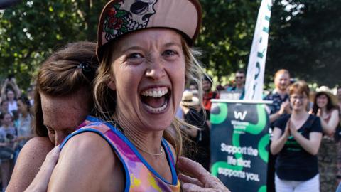 Erchana Murray-Bartlett reacts after reaching the finishing line