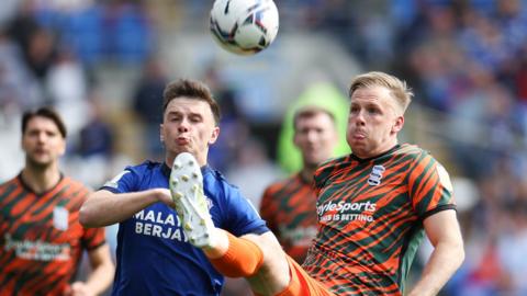 Marc Roberts of Birmingham City clears the ball as Mark Harris of Cardiff City