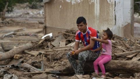 A man and his daughter remain amid rubble in Mocoa, Putumayo department, Colombia on April 4, 2017.