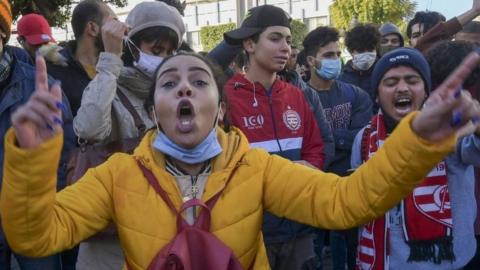 Tunisian protesters shout slogans during an anti-government demonstration on the Habib Bourguiba avenue in the capital Tunis, on January 19, 2021.