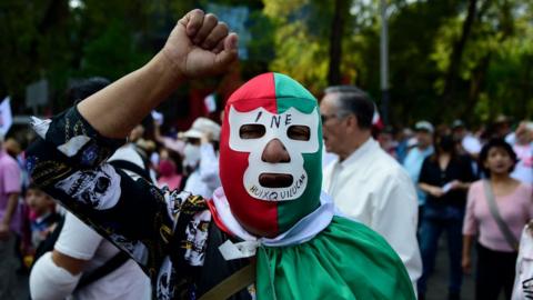 Demonstrators take part in a march against the possible government measures to restructure the National Electoral Institute (INE), in Mexico City on November 13, 2022.