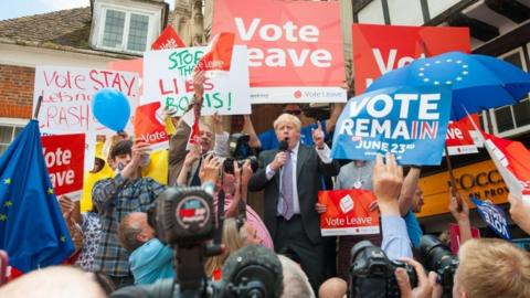 Boris Johnson surrounded by Vote Leave and Vote Remain campaigners