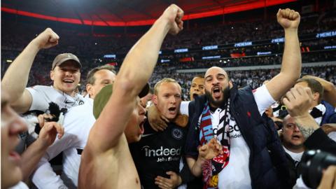 Eintracht Frankfurt's Sebastian Rode celebrates with fans after reaching the Europa League final after the match