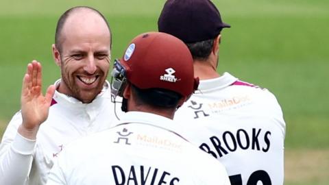 Jack Leach celebrates with Somerset teammates.