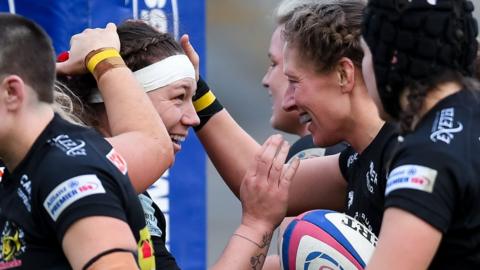 Hope Rogers and Kate Zackary celebrate a try