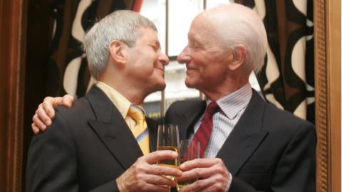 Percy Steven shares champagne with Roger Lockyer on their wedding day