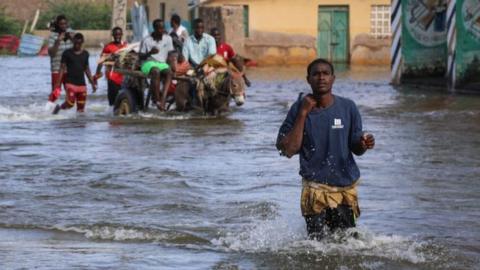 Man walking through flooded streets of Somalia