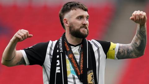 Kyle Cameron celebrates after Notts County secure promotion at Wembley