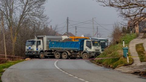 Trucks block a road in Kosovo