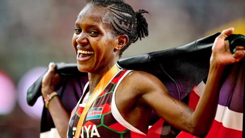 Kenya's Faith Kipyegon celebrates winning a gold medal at the World Athletics Championships in Budapest in August