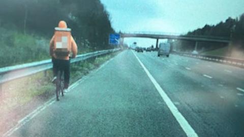 Cyclist on motorway