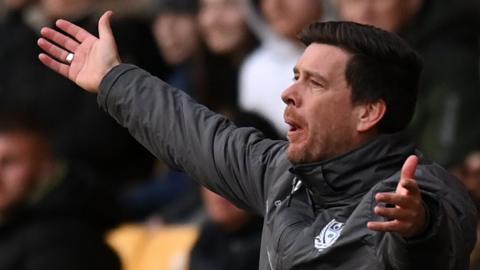 Port Vale boss Darrell Clarke shows his frustration on the sideline