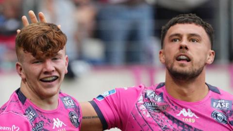 George Marsden (left) celebrates his try for Wigan Warriors against Catalans Dragons