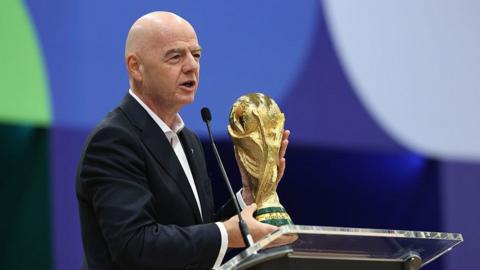 Gianni Infantino holding the World Cup trophy