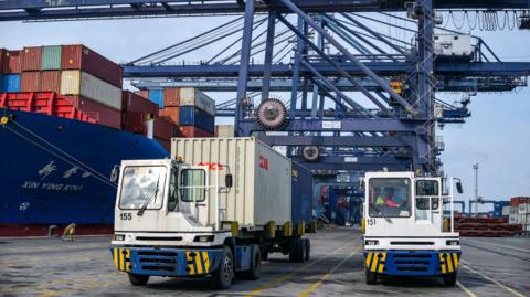 Containers are loaded on cargo trucks at the Jakarta International Container Terminal in Tanjung Priok Port, Jakarta on July 7, 2025. 
