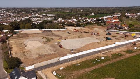 A drone photo of the building site at Overdale, with diggers and other construction vehicles visible, along with mounds of dirt.