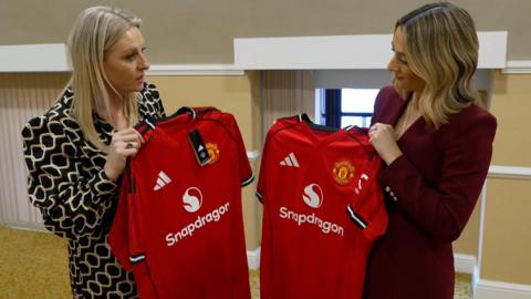 A fake Manchester United shirt held next to a replica shirt