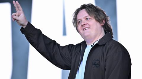 Lewis Capaldi gives the peace sign on stage at Glastonbury