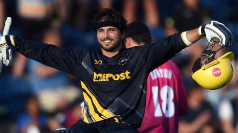 Kiran Carlson celebrates scoring a century against Somerset
