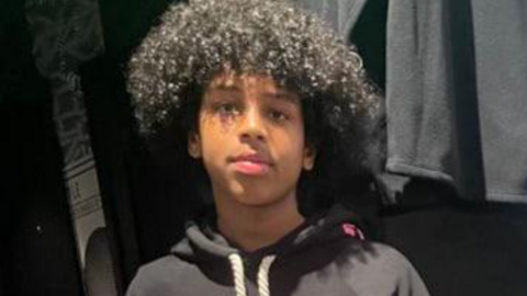 Mohanad Abdullaahi Goobe. He had short curly hair and is wearing a dark hoodie.