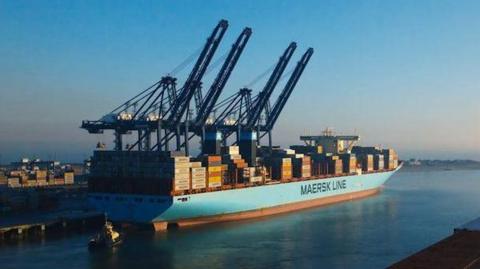 A large ship with containers on top coming in to Harwich International Port