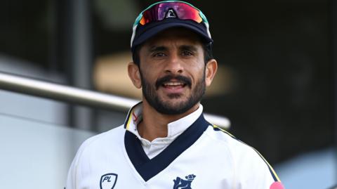 Hasan Ali wearing a Warwickshire sweater