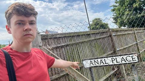 Councillor James Vivian with the 'Anal Place' road sign