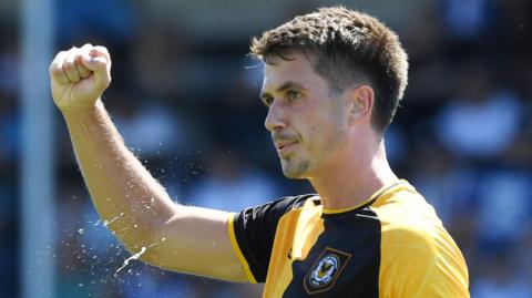 Oliver Greaves celebrates after scoring for Newport against Worcester
