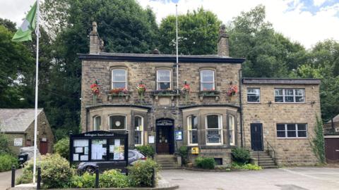 Bollington Town Council's office with an information board in front