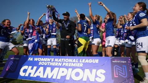 Ipswich Town manager Joe Sheehan holds the WNL Southern Premier Trophy aloft
