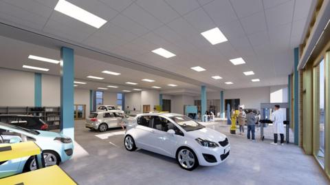 A large white room full of new cars and a few people standing around looking at them