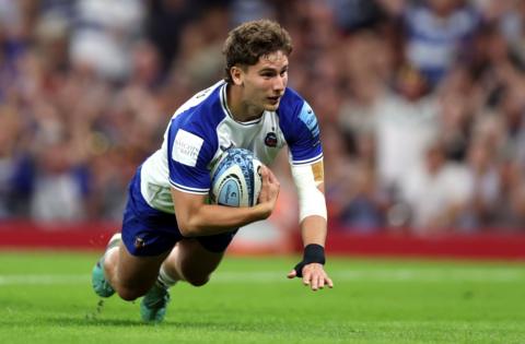 Bath's Ciaran Donoghue scores the opening try of the game against Bristol in Cardiff. He is wearing the Bath change kit of white with blue sleeves