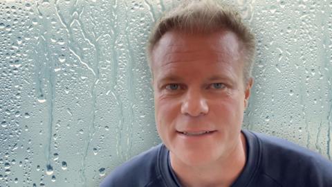 Simon King superimposed on a background of condensation on a window