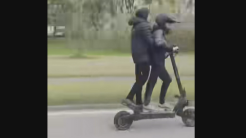 Two young people on an e-scooter