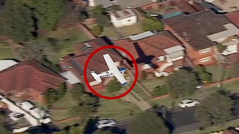 Light plane flying over houses