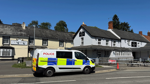 Police van and cordon outside The Church Inn