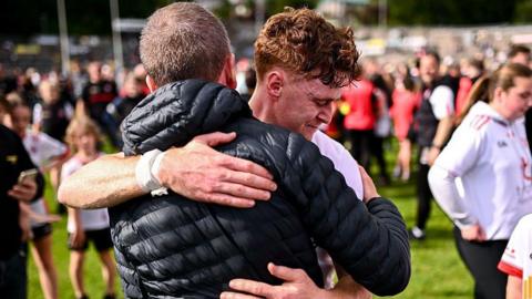 Conor Meyler hugs his dad after Tyrone beat Cavan
