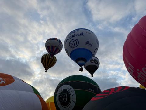 Hot air balloons ascending into the skies