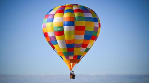 A multi-coloured hot air balloon.