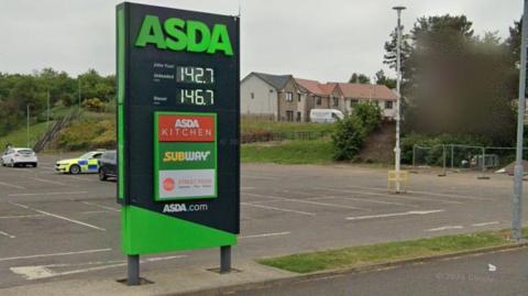 An ASDA petrol station sign in a carpark.