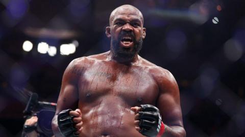 Jon Jones celebrates after beating Stipe Miocic in November 2024